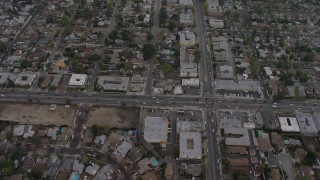 AX64_0152 - 5K aerial stock footage bird's eye of suburban neighborhoods and busy streets in Van Nuys, California, twilight