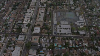 AX64_0153 - 5K aerial stock footage bird's eye view of suburban neighborhoods and an elementary school, Van Nuys, California, twilight