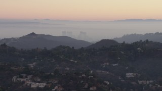 AX64_0157 - 5K aerial stock footage of Century City high-rises and Hollywood Hills mansions, California, twilight