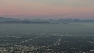 AX64_0158 - 5K stock footage aerial video of Santa Susana Mountains and neighborhoods in San Fernando Valley, Los Angeles, California, twilight