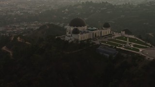 AX64_0170E - 5K aerial stock footage approach and flyby the Griffith Observatory, Los Angeles, California, twilight