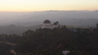 AX64_0173 - 5K aerial stock footage of reverse view of the Griffith Observatory, Los Angeles, California, twilight