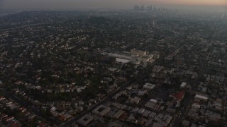 AX64_0174E - 5K aerial stock footage of apartment buildings and urban homes, reveal Downtown Los Angeles skyline, Los Feliz, California, twilight