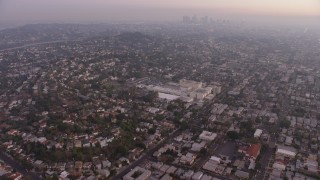 AX64_0175 - 5K aerial stock footage tilt from urban homes in Los Feliz, reveal Downtown Los Angeles, California, twilight