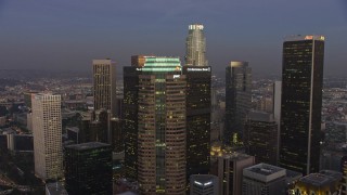 AX64_0207 - 5K aerial stock footage flyby Figueroa at Wilshire skyscraper in Downtown Los Angeles, California, twilight