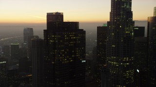 AX64_0214 - 5K aerial stock footage flyby Gas Company Tower and 611 Place in Downtown Los Angeles, California, twilight