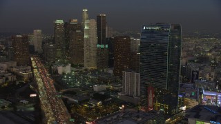 AX64_0224 - 5K stock footage aerial video of 110 Freeway, Downtown Los Angeles skyscrapers, The Ritz-Carlton, California, twilight