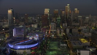 AX64_0226 - 5K aerial stock footage of Downtown Los Angeles skyscrapers behind Staples Center and Ritz-Carlton, California, twilight