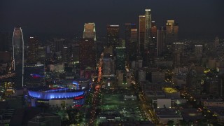 AX64_0232E - 5K aerial stock footage of Downtown Los Angeles skyscrapers and reveal Staples Center arena, California, twilight