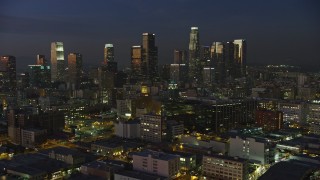 AX64_0243E - 5K aerial stock footage approach Downtown Los Angeles office buildings and skyscrapers, California, twilight