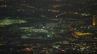AX64_0254E - 5K aerial stock footage of tracking a helicopter and reveal Twin Towers prison, Downtown Los Angeles, California, Night