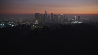 AX64_0258E - 5K aerial stock footage fly over hill to reveal the Downtown Los Angeles skyline, California, twilight