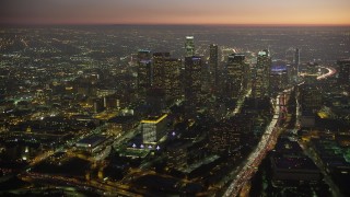 AX64_0264 - 5K aerial stock footage of Downtown Los Angeles skyscrapers, concert halls, and the 110 freeway, California, twilight