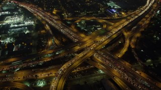 AX64_0273 - 5K stock footage aerial video of I-10 and 110 freeway interchange with heavy traffic, Downtown Los Angeles, California, night
