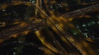 AX64_0273E - 5K aerial stock footage of I-10 and 110 freeway interchange with heavy traffic, Downtown Los Angeles, California, night