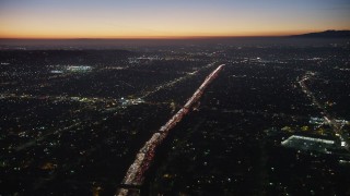 AX64_0278 - 5K aerial stock footage fly over Mid-City neighborhoods and I-10 traffic, Los Angeles, California, twilight