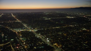 AX64_0287 - 5K aerial stock footage of city traffic on Venice Boulevard, Palms, Los Angeles, California, twilight