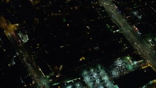 AX64_0289 - 5K aerial stock footage of bird's eye view of a neighborhood beside Venice Boulevard in Palms, Los Angeles, California, night