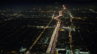 AX64_0290 - 5K aerial stock footage of heavy traffic on I-405 freeway through Sawtelle, Los Angeles, California, night