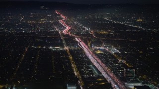AX64_0290E - 5K aerial stock footage of heavy traffic on I-405 freeway through Sawtelle, Los Angeles, California, night