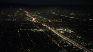 AX64_0291 - 5K stock footage aerial video of Interstate 405 freeway with heavy traffic in Sawtelle, Los Angeles, California, night