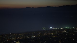 AX64_0294 - 5K aerial stock footage of the Santa Monica Pier at night in Los Angeles, California