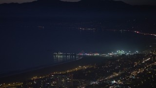 AX64_0294E - 5K aerial stock footage of the Santa Monica Pier at night in Los Angeles, California