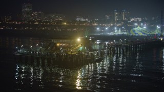 AX64_0302E - 5K aerial stock footage flyby the end of Santa Monica Pier, Los Angeles, California, night