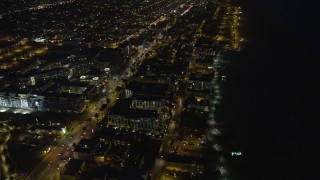 AX64_0308E - 5K aerial stock footage of Ocean Avenue and Loews Santa Monica Beach Hotel, Santa Monica, California, night