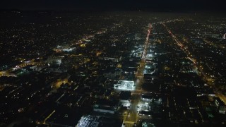AX64_0310E - 5K aerial stock footage of Santa Monica Boulevard and Arizona Avenue, Santa Monica, California night