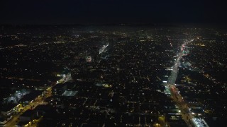 AX64_0313E - 5K aerial stock footage of flying between Santa Monica and Wilshire Boulevards, Santa Monica, California, night