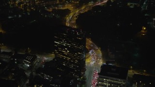 AX64_0317 - 5K aerial stock footage fly over Wilshire Boulevard and a tall office building at night, Sawtelle, Los Angeles, California