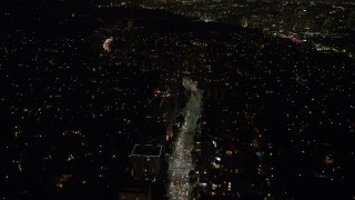 AX64_0320 - 5K aerial stock footage of Wilshire Boulevard and condominium complexes in Westwood, Los Angeles, California, night