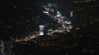 AX64_0325E - 5K aerial stock footage of approaching the Sunset Strip in West Hollywood, California, night