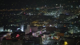 AX64_0333E - 5K aerial stock footage of Roosevelt Hotel and office buildings on Hollywood Boulevard in Hollywood, California, night