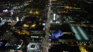 AX64_0337 - 5K stock footage aerial video follow Sunset Boulevard and fly over ArcLight Hollywood, California, night