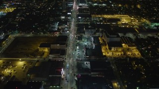 AX64_0337E - 5K aerial stock footage follow Sunset Boulevard to 101 freeway, fly over ArcLight Hollywood, California, night