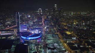 AX64_0363E - 5K aerial stock footage fly over Staples Center toward Downtown Los Angeles skyscrapers, California, night