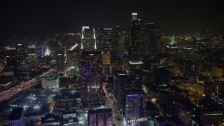 AX64_0364 - 5K aerial stock footage of approaching the tall skyscrapers of Downtown Los Angeles, California, night