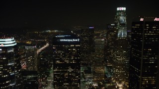 AX64_0366 - 5K aerial stock footage of flying over tall skyscrapers in Downtown Los Angeles, California, night
