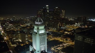 AX64_0370 - 5K stock footage aerial video flyby Los Angeles City Hall to focus on the Downtown Los Angeles skyline, California, night