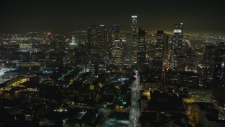 AX64_0379E - 5K aerial stock footage follow 6th Street to approach Downtown Los Angeles and skyscrapers, California, night