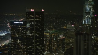 AX64_0391E - 5K aerial stock footage approach Aon Center and tilt to Westin Bonaventure Hotel, Downtown Los Angeles, California, night