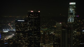 AX64_0392 - 5K aerial stock footage approach Aon Center and tilt to Westin Bonaventure Hotel, Downtown Los Angeles, California, night