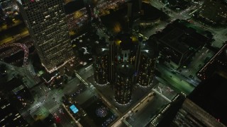 AX64_0394 - 5K stock footage aerial video tilt to bird's eye of Westin Bonaventure Hotel and city streets, Downtown Los Angeles, California, night