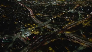 AX64_0395E - 5K aerial stock footage bird's eye of heavy traffic on the 110 and 101 freeway interchange, Downtown Los Angeles, California, night