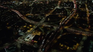 AX64_0396 - 5K aerial stock footage of the 110 and 101 freeway interchange, Downtown Los Angeles, California, night