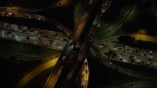 AX64_0399 - 5K stock footage aerial video bird's eye view of Highway 110 and Highway 101 interchange, Downtown Los Angeles, California, night