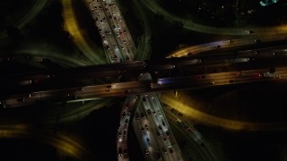 AX64_0400 - 5K stock footage aerial video bird's eye of traffic on the 110 / 101 freeway interchange, Downtown Los Angeles, California, night
