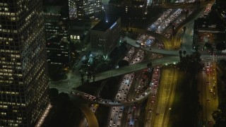 AX64_0402E - 5K aerial stock footage tilt to heavy traffic on Highway 110, Downtown Los Angeles, California, night